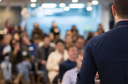 a speaker speaking at a conference